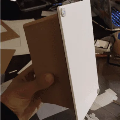An early prototype shell, held for scale.
